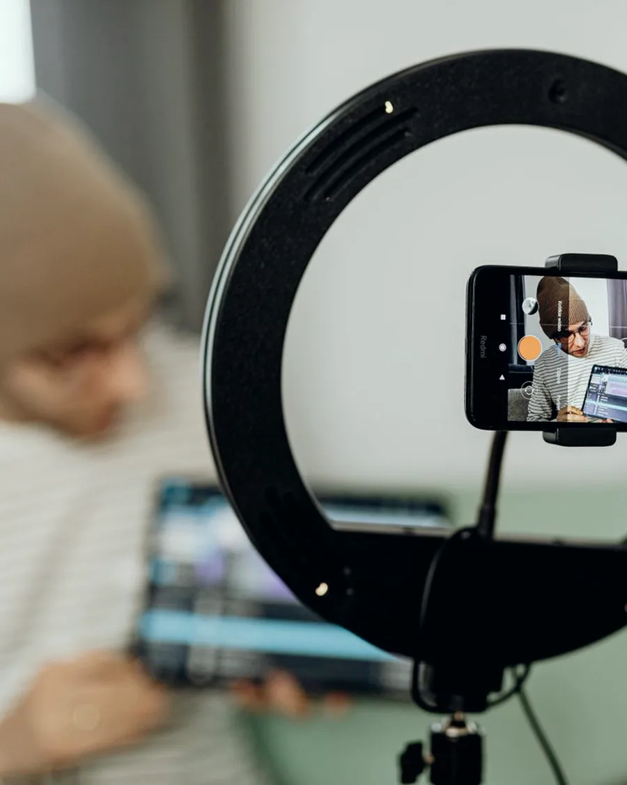 A phone on a ring light showing a video being recorded